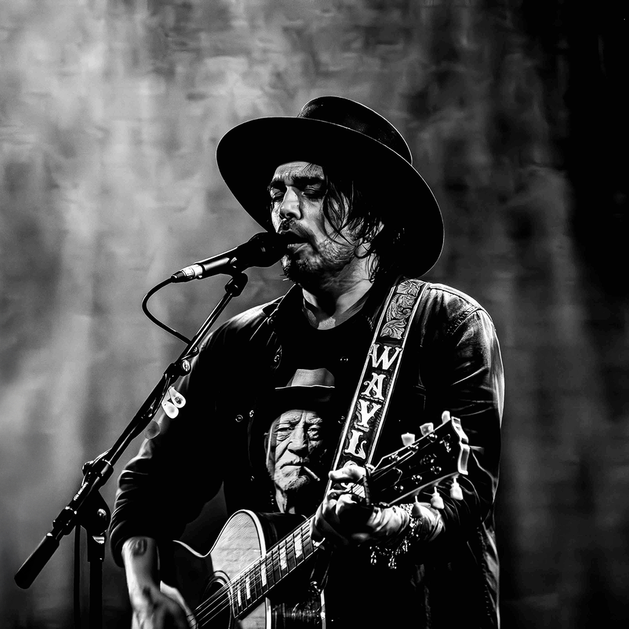 Waylon zingend en gitaar spelend in zwart wit