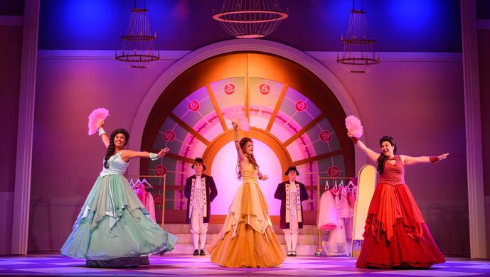 De drie feeën van Doornroosje dansen met een waaier.