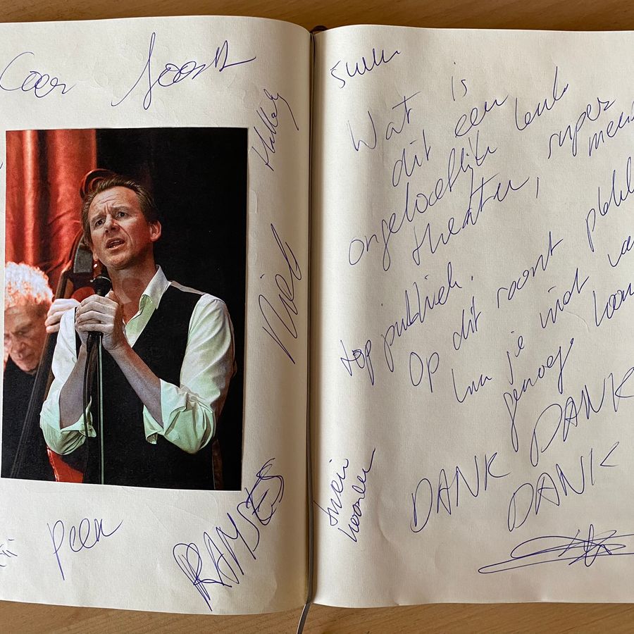 Opengeslagen gastenboek met foto en handgeschreven tekst